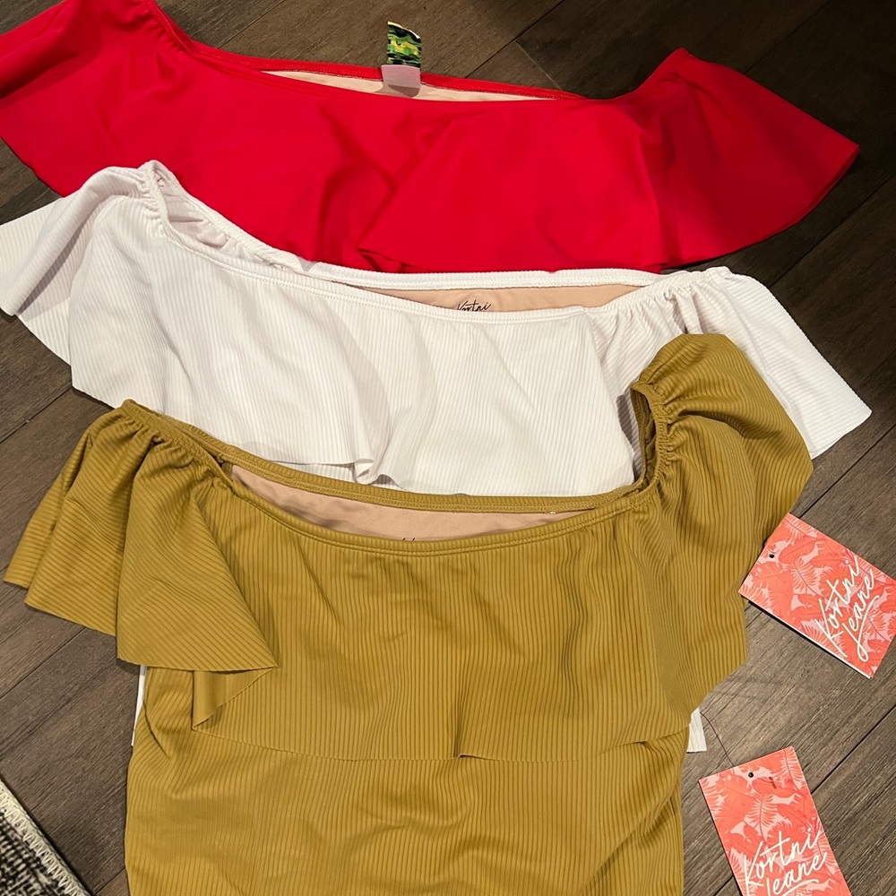 Two Kortni Jeane ruffle around tops. White one sold; not included